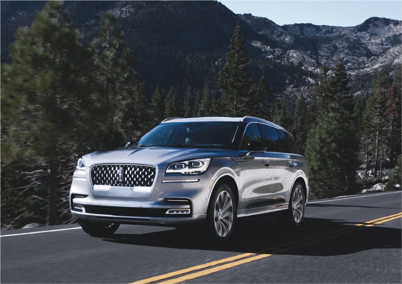 A 2023 Lincoln Aviator® Grand Touring SUV being driven on a winding road to demonstrate the capabilities of all-wheel drive | Palmetto Lincoln in Charleston SC