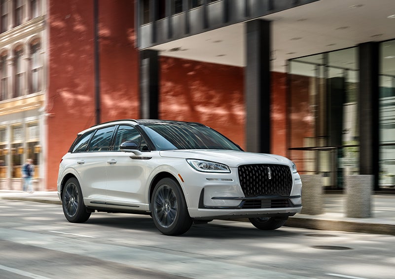 The 2024 Lincoln Corsair® SUV with the Jet Appearance Package and a Pristine White exterior is parked on a city street. | Palmetto Lincoln in Charleston SC