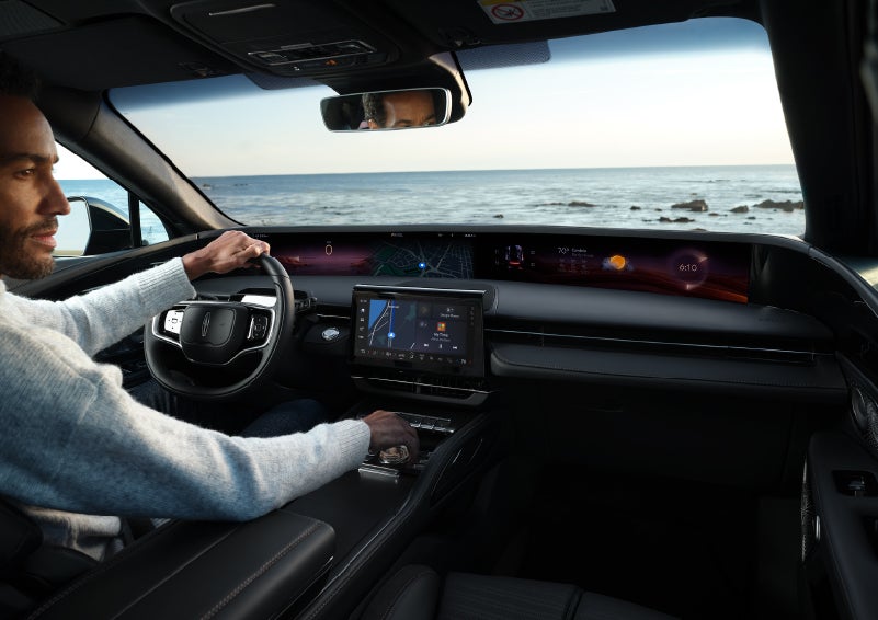 A driver of a parked 2024 Lincoln Nautilus® SUV takes a relaxing moment at a seaside overlook while inside his Nautilus. | Palmetto Lincoln in Charleston SC